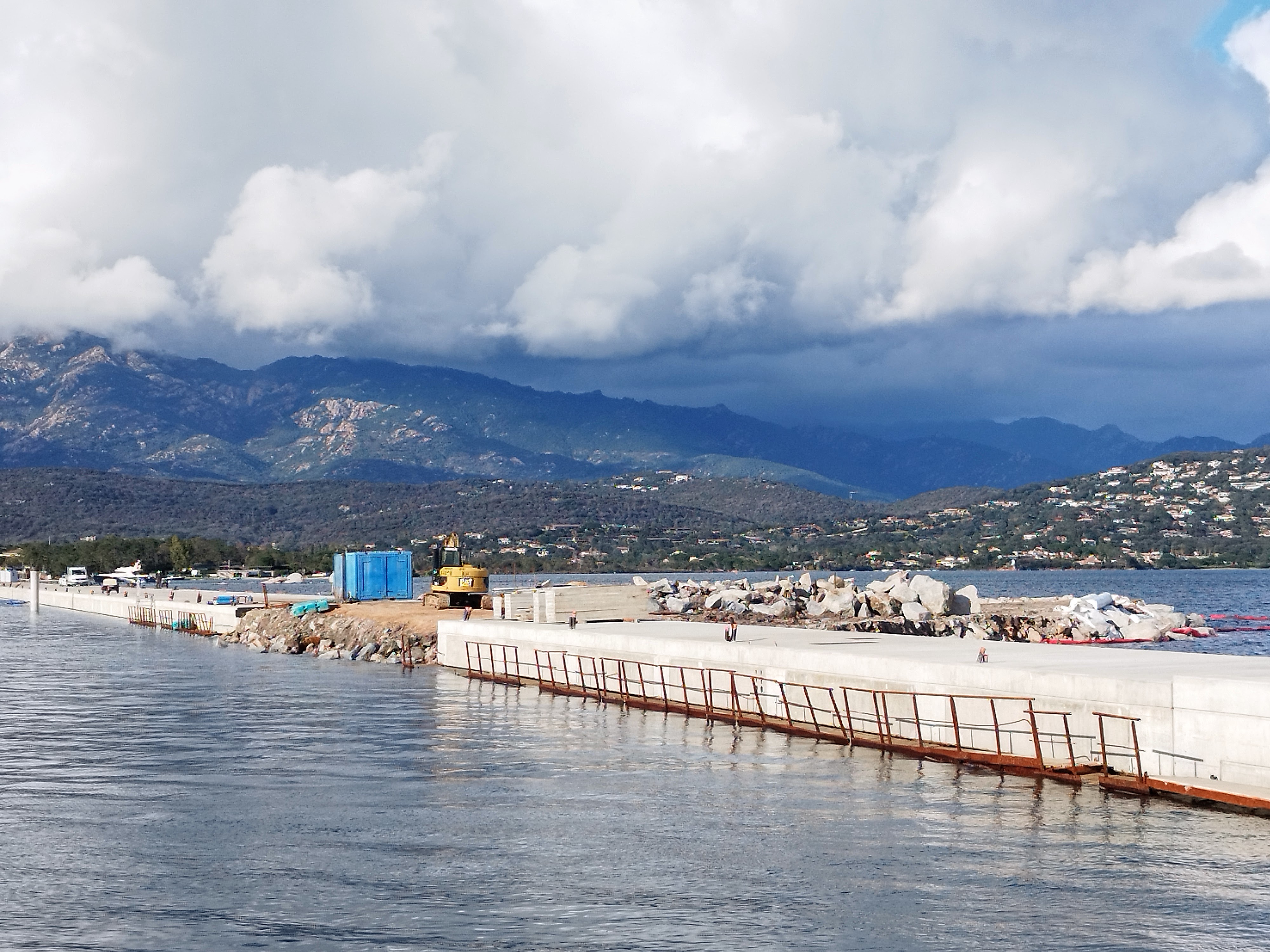 Au milieu de la digue brise-clapôt, une île artificielle constituée de sable dragué au fond du port.